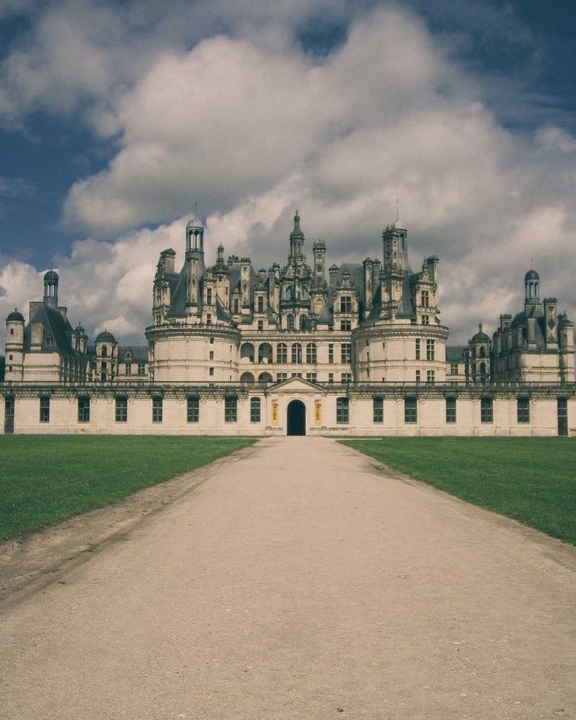 A grand European chateau at the end of a long gravel path